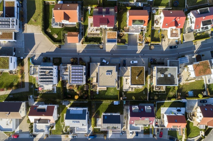Residential neighborhood, aerial view of solar roofing that provides a home with green energy.