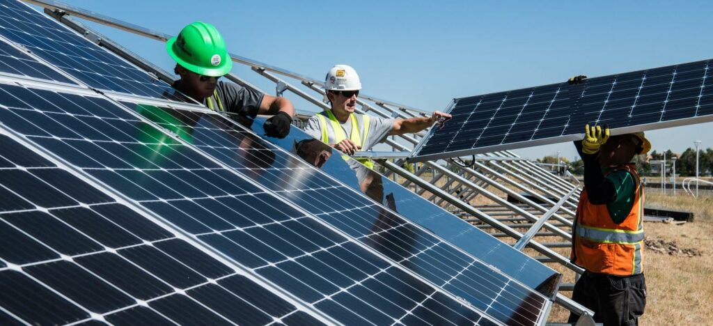 Construction workers installing solar panels