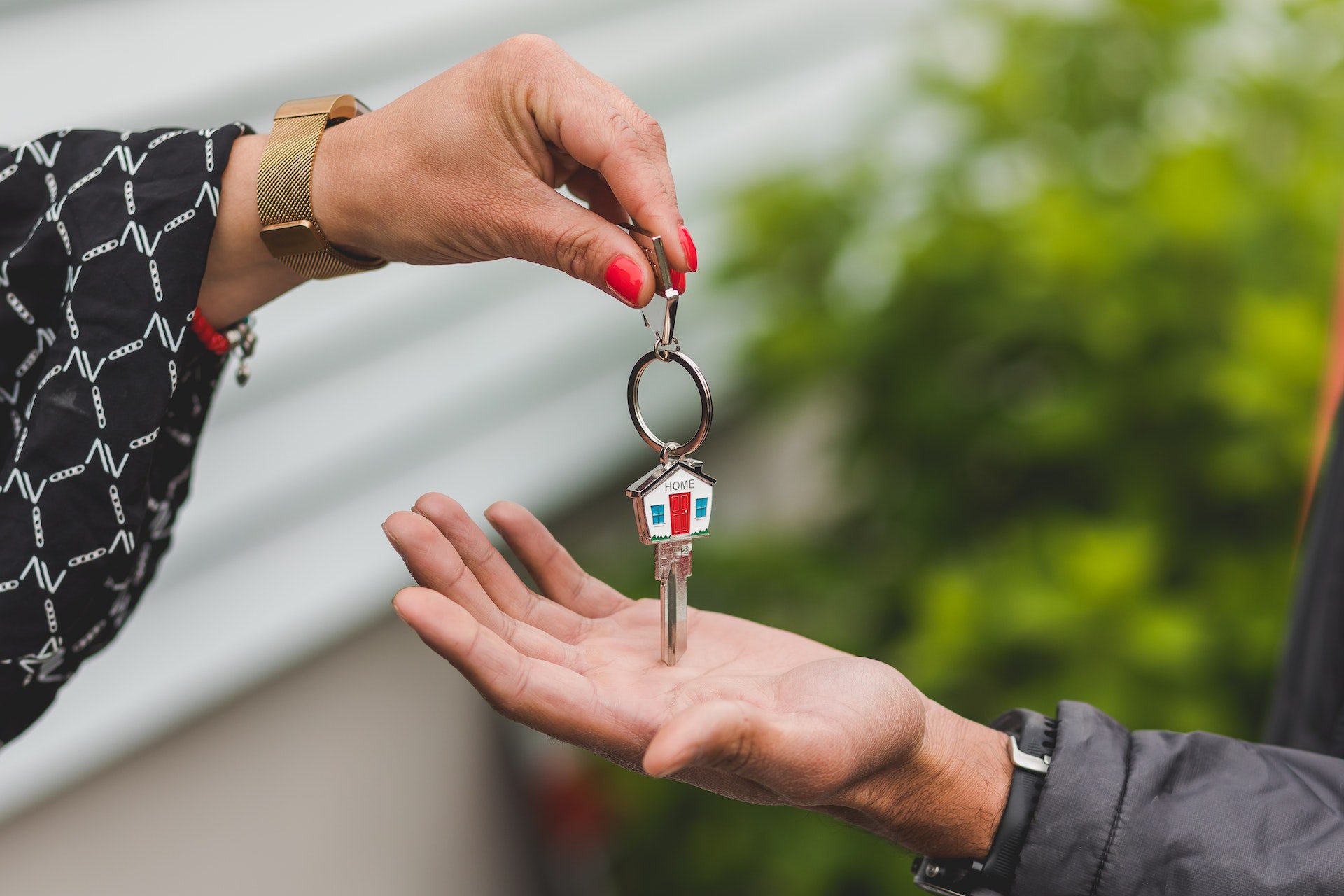 Realtor handing a house key to the new home buyer