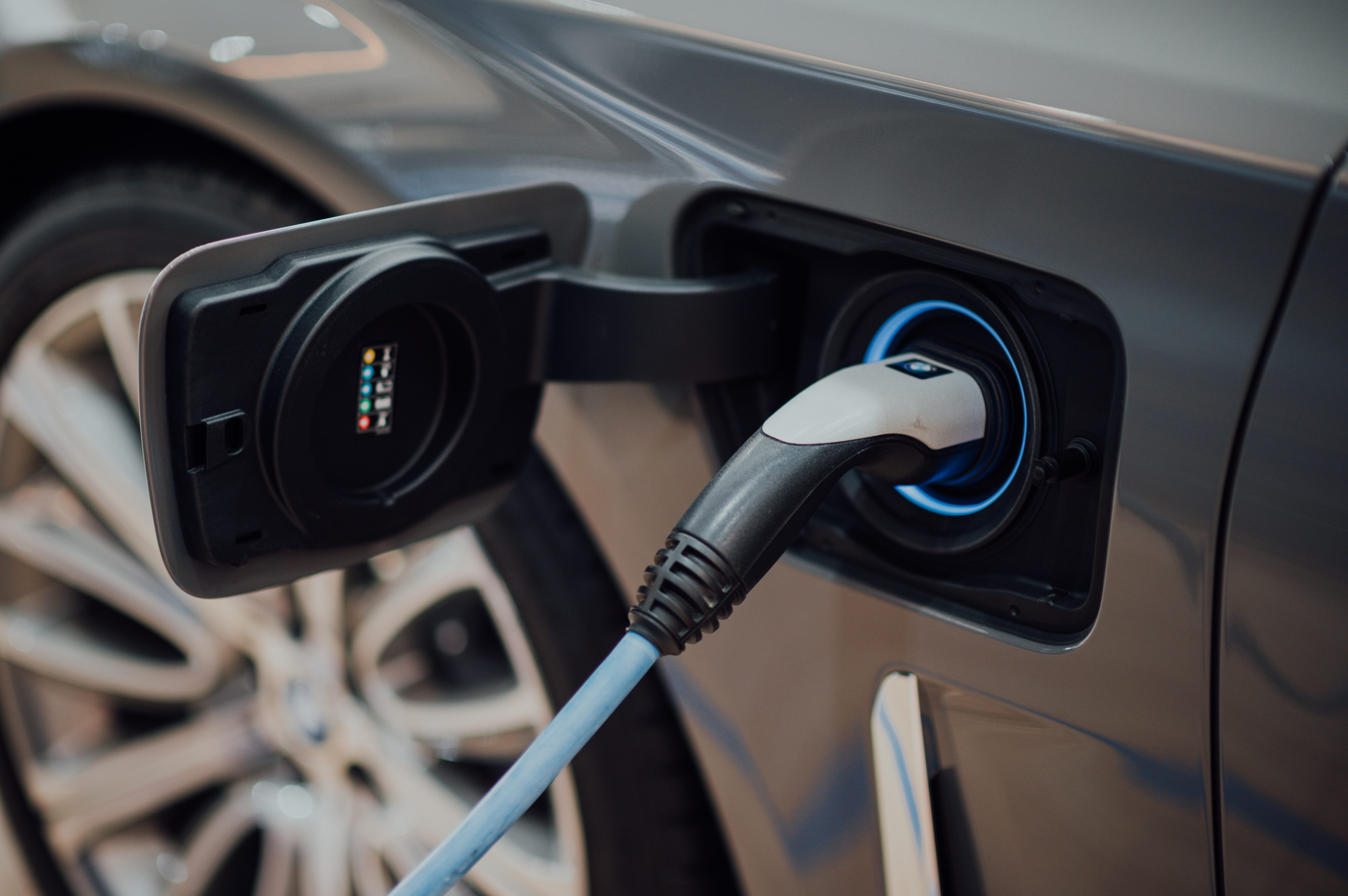 Close up of an electric car charger plugged into an EV